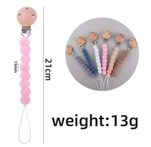 Detail of 21cm baby pacifier clip with 15mm colorful plush balls and wooden holder