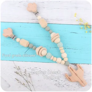 Detail of baby teether with beech wood cactus clip and green silicone beads
