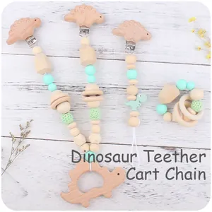 Detail of dinosaur wooden teether set with silicone beads and crochet balls for strollers