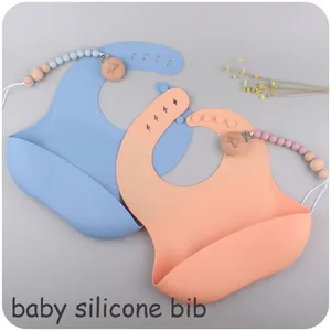 Detailed view of soft silicone baby bibs with wide pockets and beaded clip chain