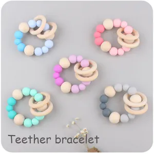 Detailed view of silicone and wooden teething bracelets in five soft pastel colors