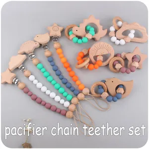 Detail of baby pacifier chain set with natural beech wood and silicone beads