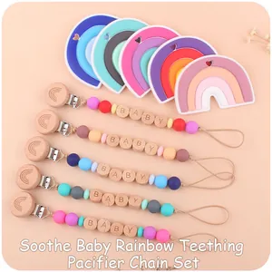 Macro shot of colorful silicone teething beads and rainbow beech wood pacifier clip