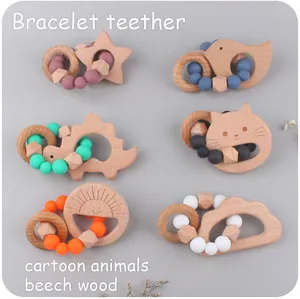 Detail of wooden beech and silicone baby teething rings with various cartoon animal shapes
