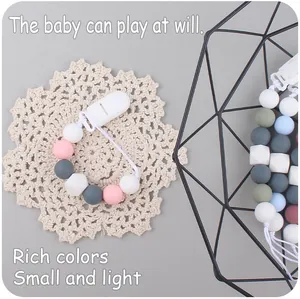 Detailed view of colorful silicone beads on pacifier clip with secure plastic buckle