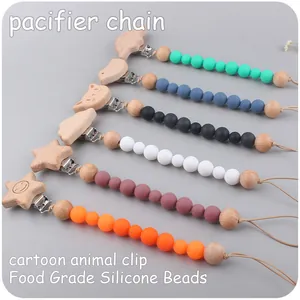Detail of baby pacifier chains with cartoon wood clips and food grade silicone beads