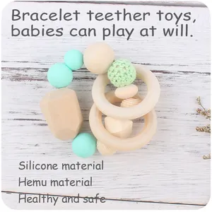 Detail of baby teething bracelet with mint silicone beads and natural hemu wood rings