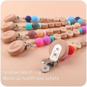 Detailed view of rainbow beech wood clips and silicone pacifier chains with baby beads