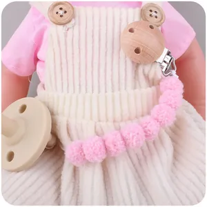 Pink plush ball baby pacifier clip with silicone soother and natural wooden clamp