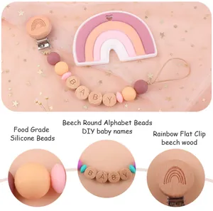 Detail of pink silicone rainbow clip and beech wood alphabet beads on baby pacifier chain