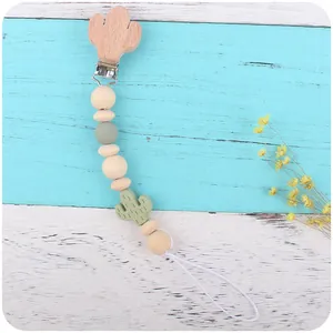 Beech wood cactus baby pacifier clip and silicone teething beads set on wood background
