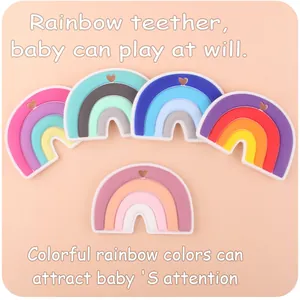 Macro view of five colorful silicone rainbow teethers with heart-shaped hanging holes
