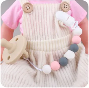 Detailed view of food-grade silicone pacifier clip with soft pink and gray beads