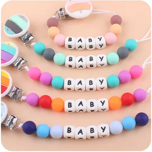Detailed view of colorful silicone baby pacifier clips with BABY letter beads