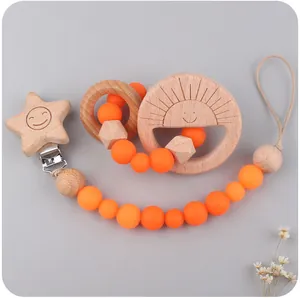 Detail of wooden sun teether with colorful silicone beads and a star-shaped clip
