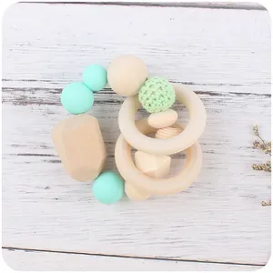 Baby teething ring with dinosaur wood charm, mint green silicone beads and crochet sphere