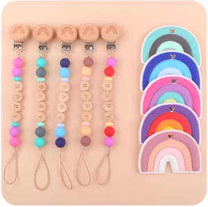 Detail of baby pacifier clips and rainbow silicone teethers with beech wood beads