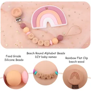 Silicone rainbow baby pacifier clip with beech wood alphabet beads on pink mesh background