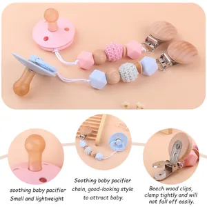 Detail of pink and blue silicone pacifiers with beech wood and bead clips in a cozy setting