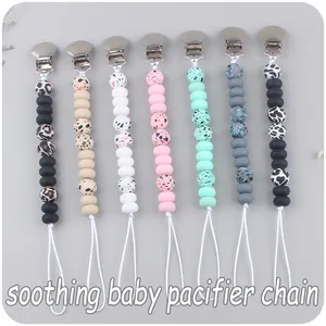 Collection of silicone baby pacifier clips in leopard, marble, and solid color patterns