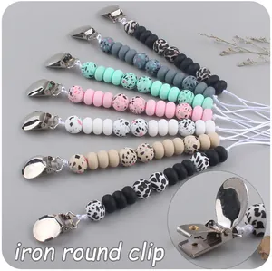Detail view of colorful leopard print silicone beads and iron round pacifier clip set