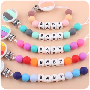 Five colorful silicone pacifier clips with BABY beads and rainbow striped metal clamps