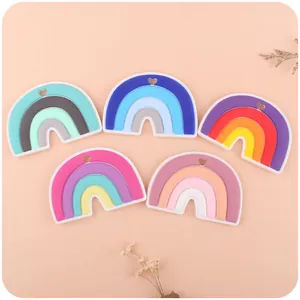 Five assorted colorful silicone rainbow teether pendants for infants with heart-shaped holes