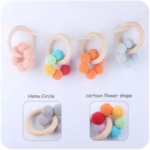 Detailed close-up of a baby beech wood teething ring with a colorful crochet cotton flower