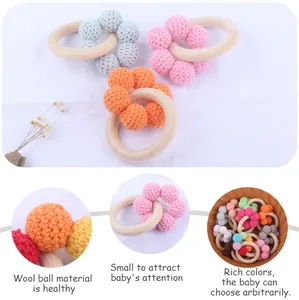 Detail of handmade crochet wool beads and natural wood ring for baby teething toy