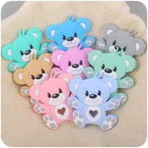 Detailed macro view of colorful bear silicone baby teethers on a soft knit background