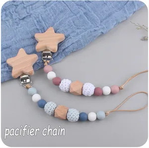 Detail of wooden star pacifier chain with silicone beads and crochet textures