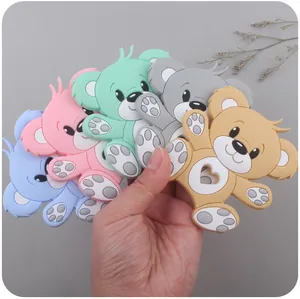 Close-up of baby silicone bear teethers in multiple colors with heart-shaped grip