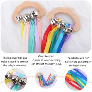 Detail view of beech wood cloud teether with colorful ribbons and silver bells for babies