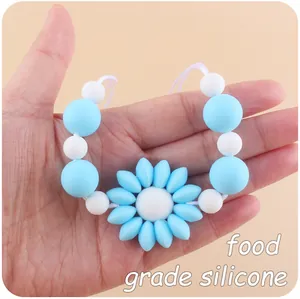 Detail of food grade silicone baby teething necklace with blue flower pendant