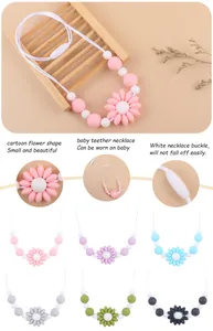Close-up of food-grade silicone teething necklace with daisy flower pendant and safety clasp