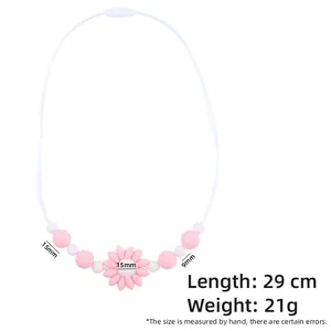 Detail view of pink and white silicone teething necklace with flower beads and dimensions