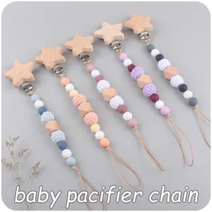 Detailed view of baby pacifier clips with star wooden clasps and colorful silicone beads