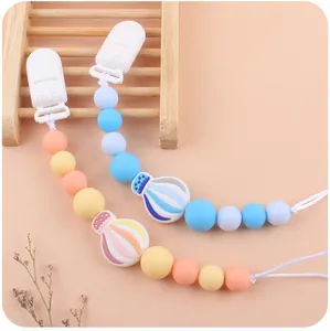 Detailed close-up of silicone pacifier chains featuring hot air balloon shaped clips