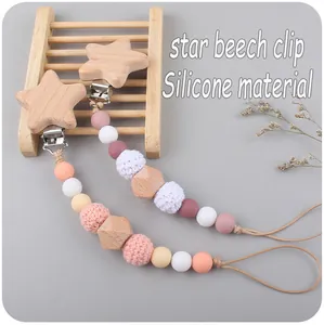 Detail of star-shaped beech wood clip and silicone beads for baby pacifier chain