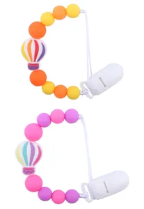 Detail of silicone pacifier clips featuring cartoon hot air balloon and colorful beads