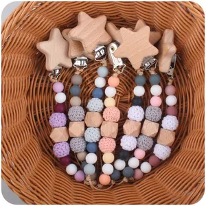 Selection of star-shaped beech wood pacifier clips with colorful silicone and crochet beads