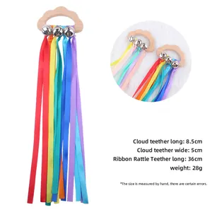 Beech wood cloud baby teether with colorful ribbons and silver bells on white backdrop