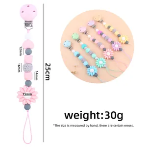 Detailed view of silicone pacifier clips in various pastel colors with flower charms