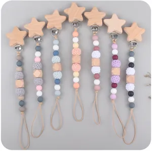 Close-up of star beechwood pacifier clips with silicone beads in various Morandi colors