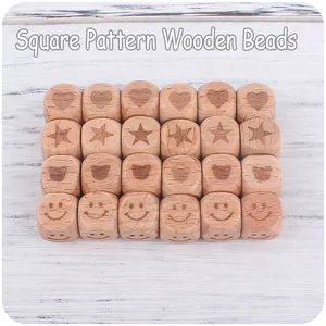 Detailed view of 12mm square beech wood beads with heart, star and bear engravings