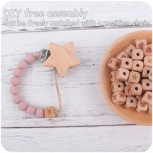 Close-up of DIY baby pacifier chain accessories featuring beech wood beads and star clip