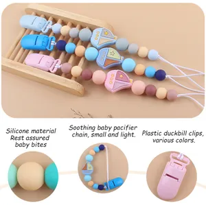 Detailed view of silicone pacifier clip with cartoon sailboat bead and safety plastic clip