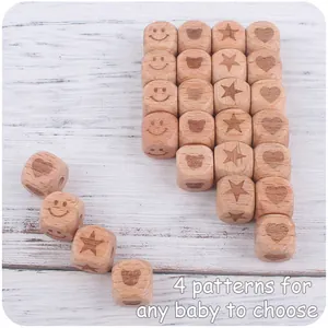 Macro view of 12mm square beech wood beads with engraved baby patterns and natural texture