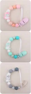 Detailed view of three colorful silicone pacifier clips with unicorn beads and clips
