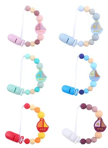 Detail view of silicone pacifier clips with cartoon sailboat beads in six colors